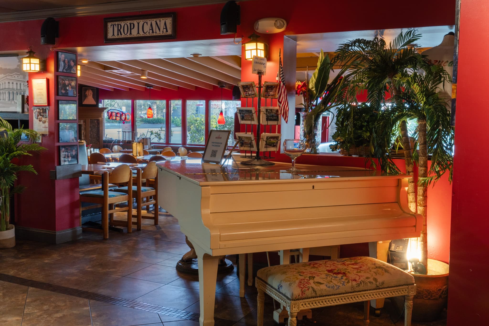The white baby grand piano beneath the Tropicana sign